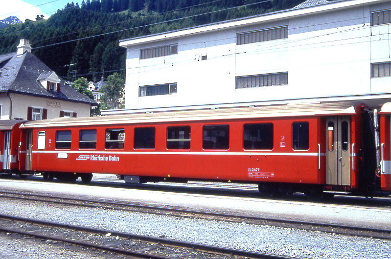 RhB - B 2427 am 06.06.1993 in Disentis - 2.Klasse Einheitspersonenwagen (Typ II) - �bernahme 24.08.1979 - FFA/SWP/RhB - Fahrzeuggewicht 15,00t - Sitzpl�tze 52/Stehpl�tze 24 - L�P 18,50m - zul�ssige Geschwindigkeit 90 km/h - �2=20.07.1988 - Logo RhB in deutsch - Anschriftenfeld flach, Klassezahlen klein, Griffstangen neben den T�ren - Hinweis: Die Fahrzeugserie besteht aus 30 Wagen mit den Nummern 2421 bis 2450. 
