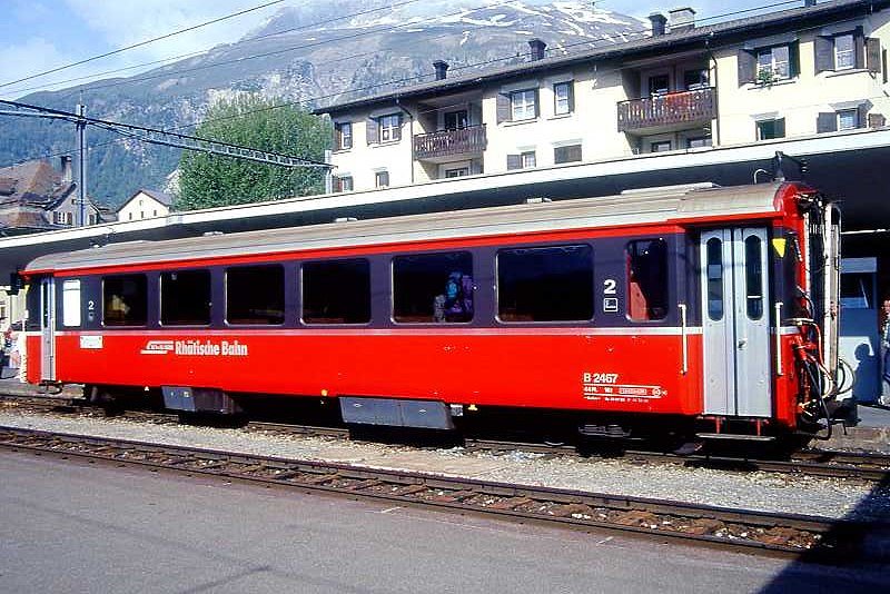 RhB - B 2467 am 30.05.1993 in Samedan - 2.Klasse verk�rzter Einheitspersonenwagen (Typ III) f�r Bernin-Express mit braunen Fensterband  - �bernahme: 29.07.1983 - FFA/SWP - Fahrzeuggewicht 16,00t - Sitzpl�tze 44 - L�P 14,45m - zul�ssige Geschwindigkeit 90 km/h - �2=26.05.1989 - Logo RhB in deutsch, Griffstangen neben den T�ren, flacher Anschriftenblock - Lebenslauf: ex B 2467 - 23.08.2010 B 641.07 - Hinweis: Die Fahrzeugserie bestand aus 8 Wagen mit den Nummern 2461 bis 2468. 
