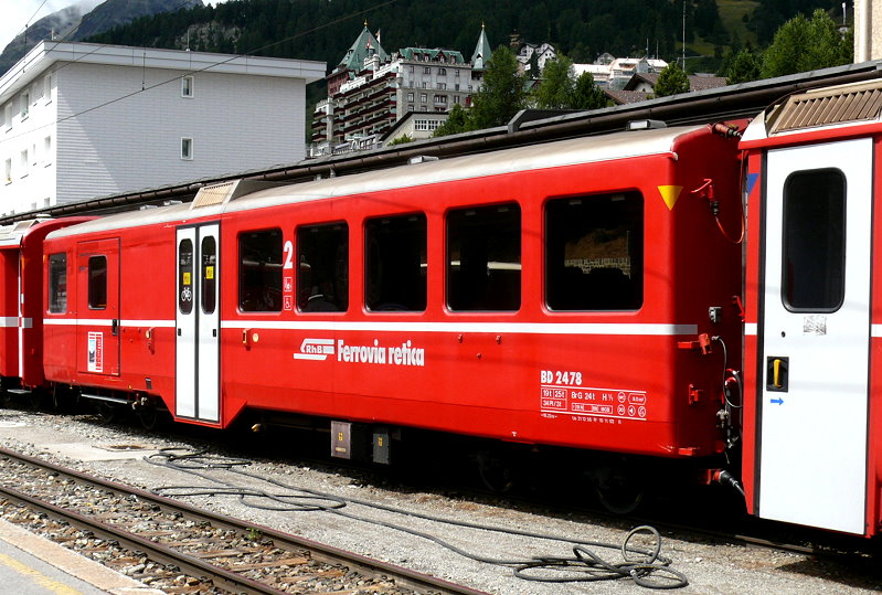 RhB - BD 2478 am 30.07.2010 in St.Moritz - 2.Klasse Personenwagen mit Gep�ckabteil f�r Stammnetz und Berninabahn - Mitteleinstiegswagen mittelschwerer Stahlbauart - �bernahme 21.12.1956 - SIG - Fahrzeuggewicht 19,00t - Sitzpl�tze 34 - Zuladung 3,00t - L�P 16,22m - zul�ssige Geschwindigkeit 90 km/h - Logo RhB in italienisch. Hinweis: Klassezahlen gro�, hoher Anschriftenblock, dicke Betriebsnummern - Lebenslauf: ex Stammnetzwagen B4� 2335 - 1964 B 2335 - 04/2003 ausr - �3=10.11.2003 verk�rzt und Umbau zu BD 2478.  
